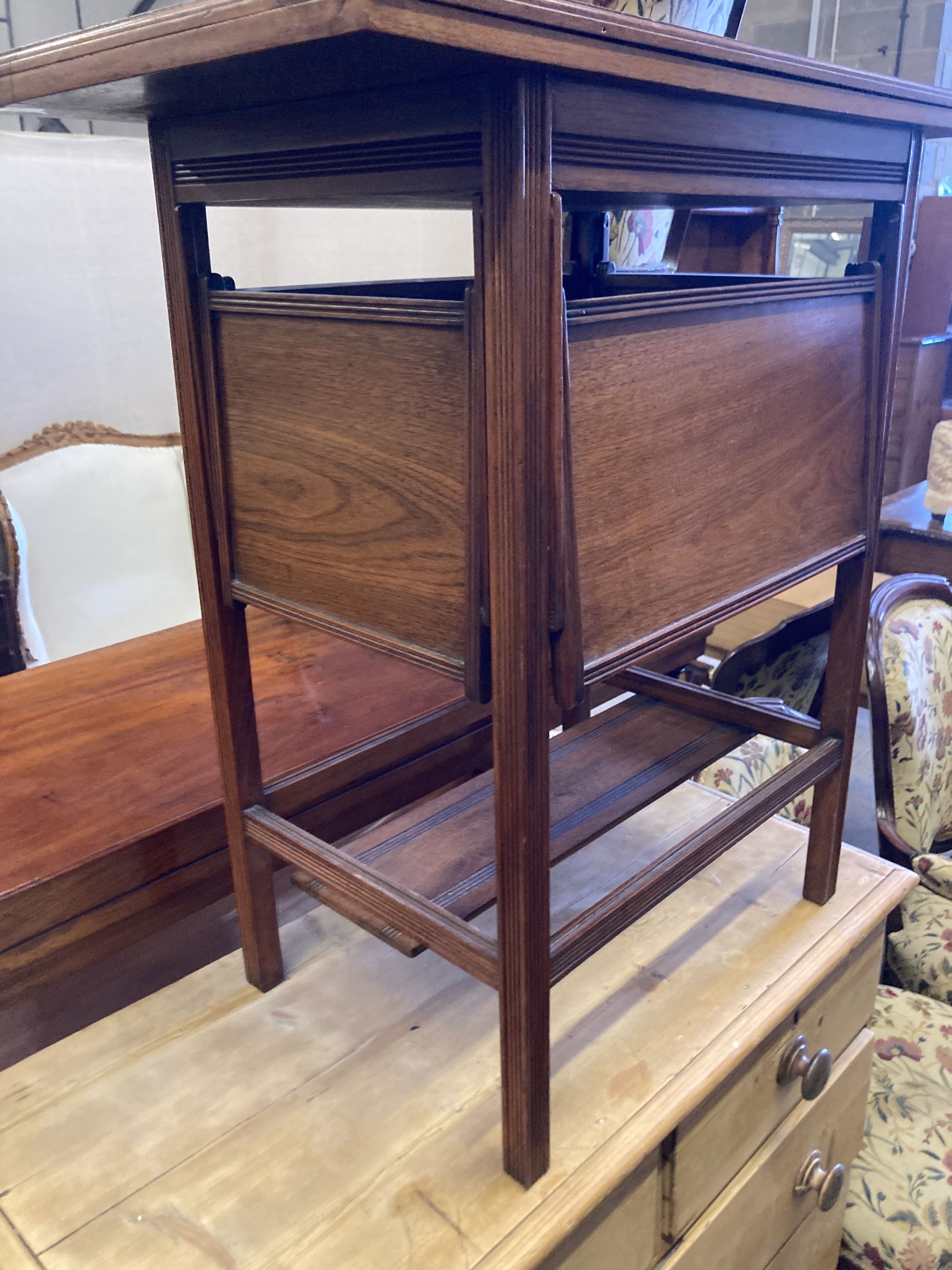 A late Victorian aesthetic movement walnut folding card table, with hinged undertiers, width 71cm, depth 38cm, height 75cm